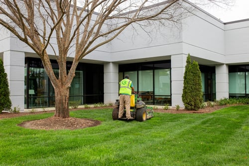 Man on mower cutting grass