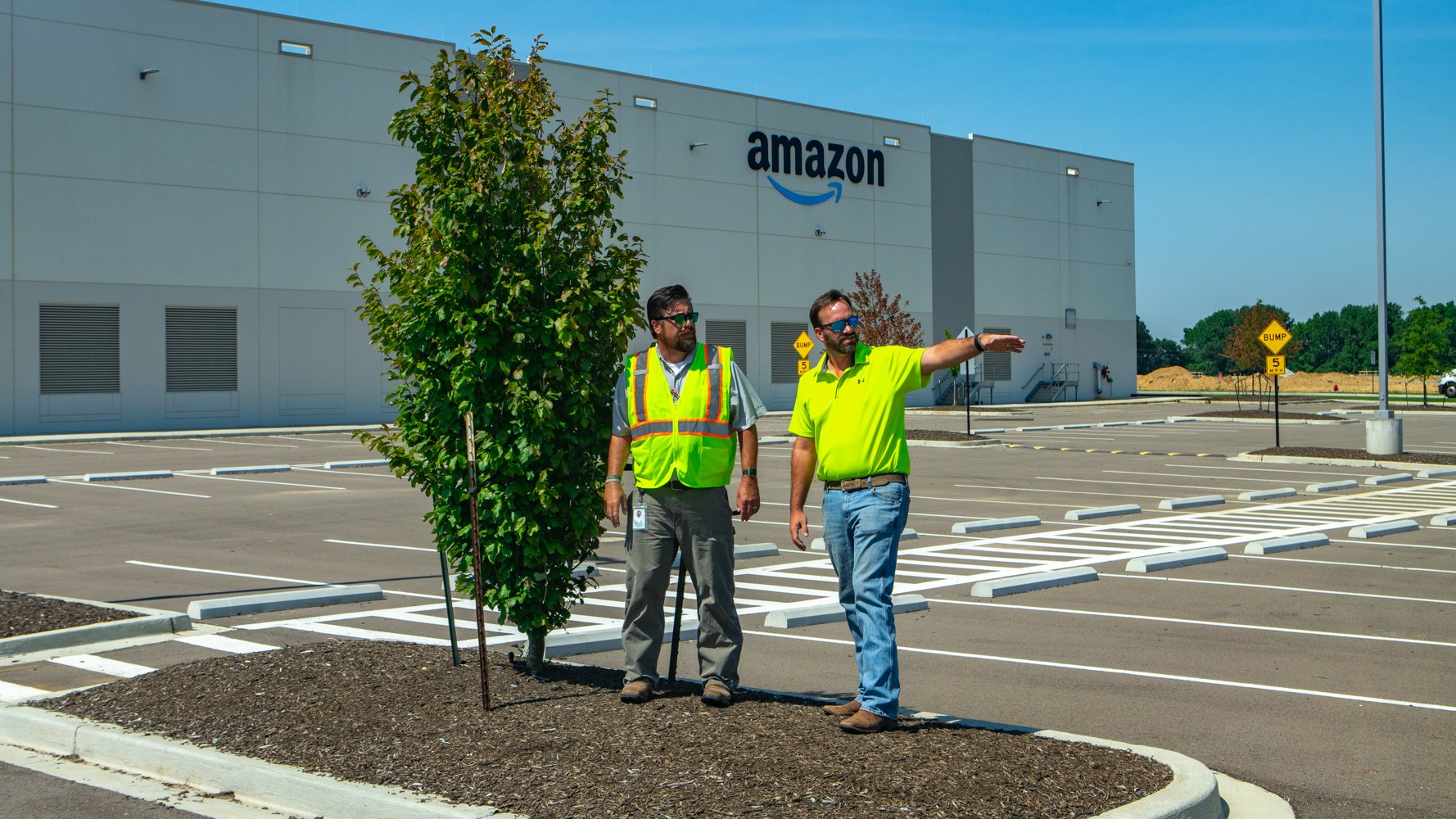 Commercial landscaping Account Manager and Company Manager inspecting the Amazon fulfillment property with the client