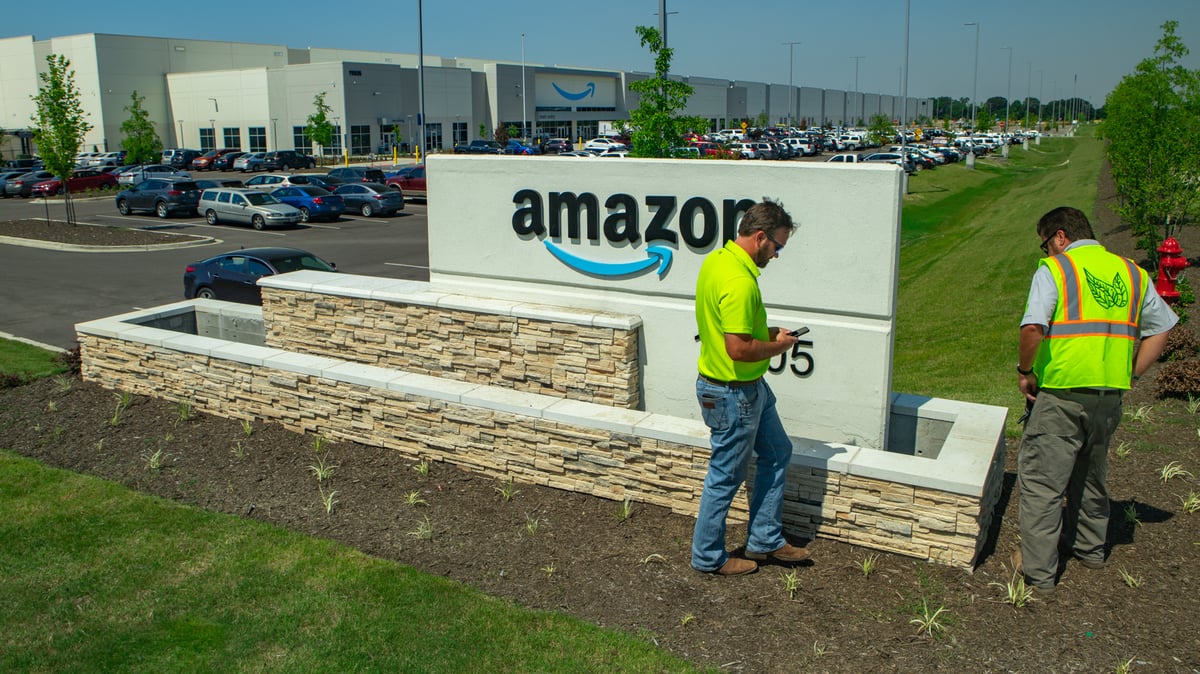account manager inspects property at amazon warehouse