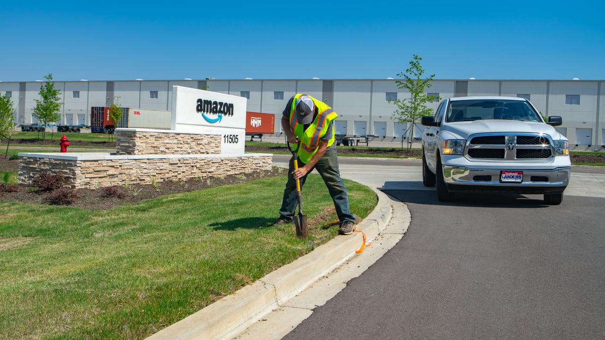 irrigation technician makes repair on broken sprinkler system