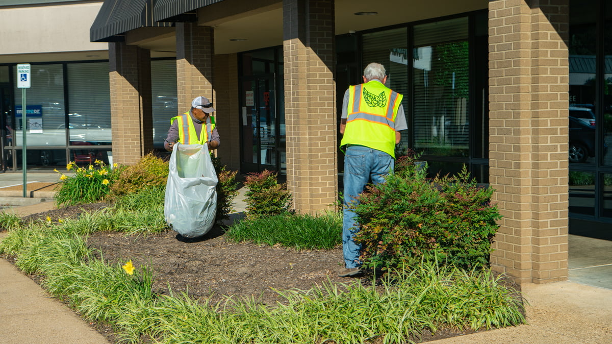 commercial landscaping crew clean out landscape bed