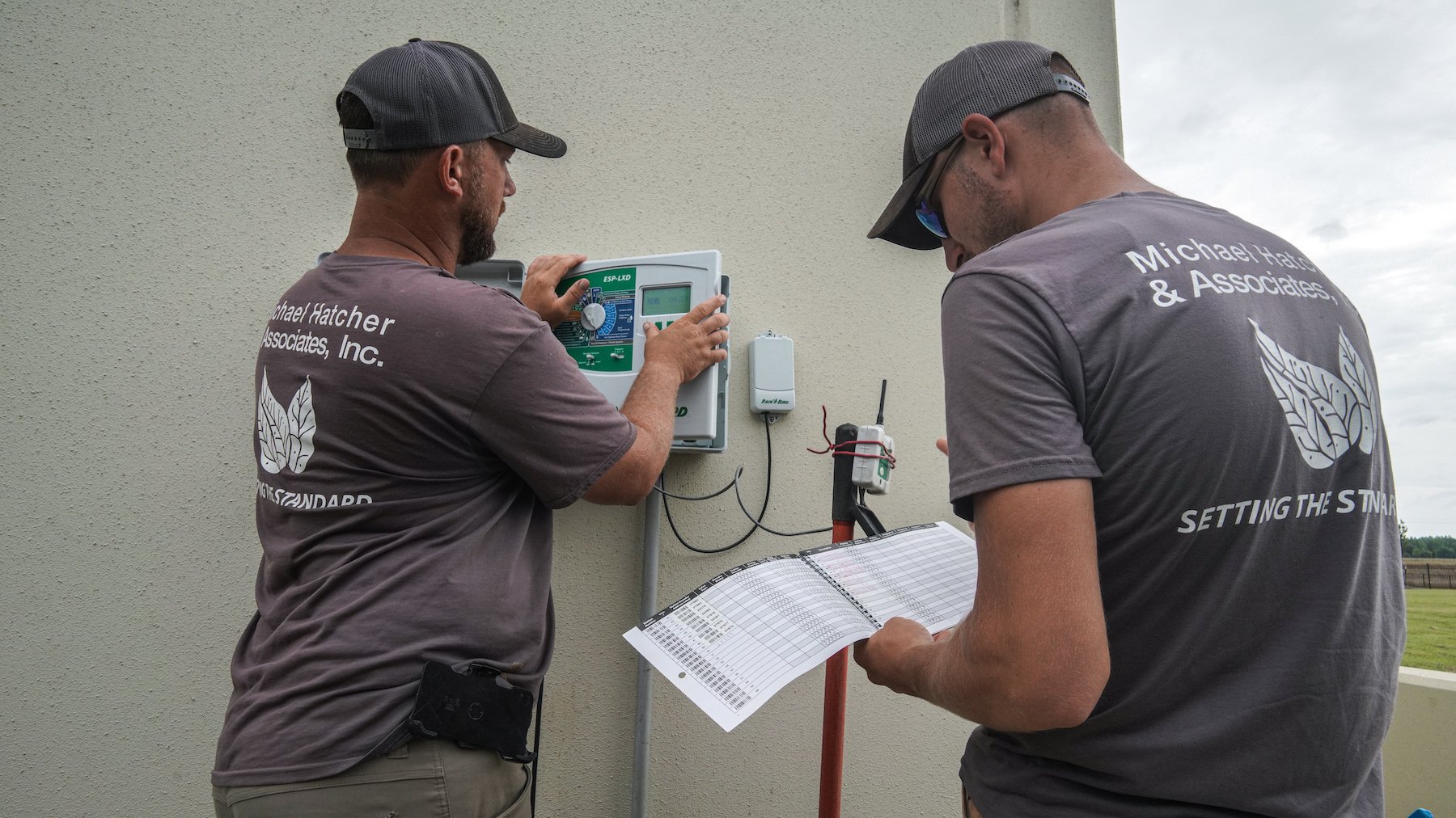 Crew performing monthly irrigation system inspection