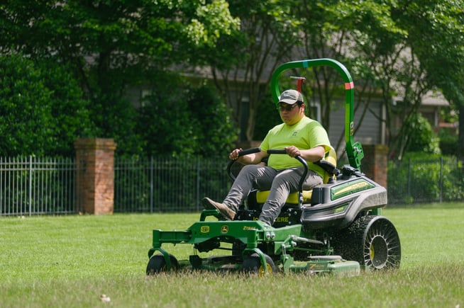 Technician mowing commercial landscape