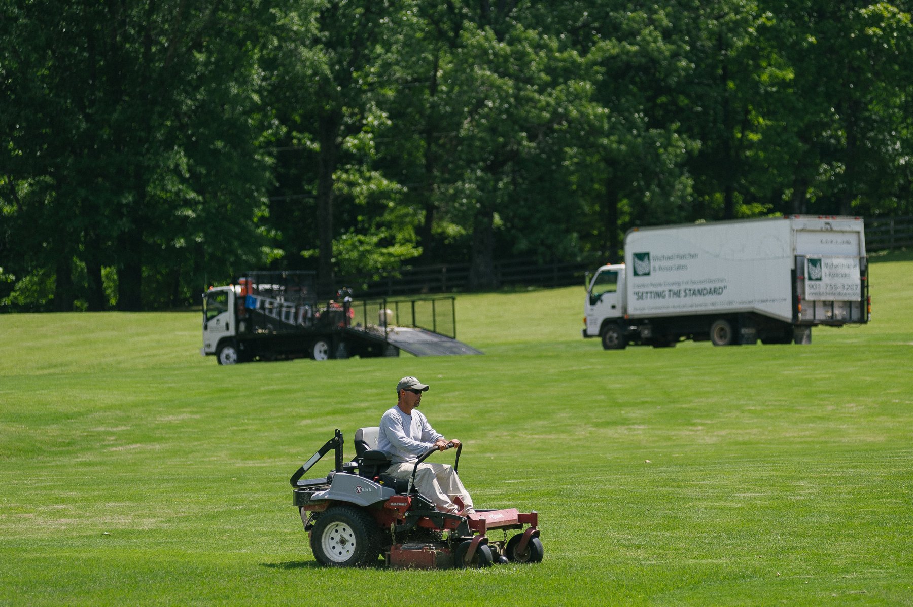 Michael Hatcher & Associates landscape maintenance crew mowing property