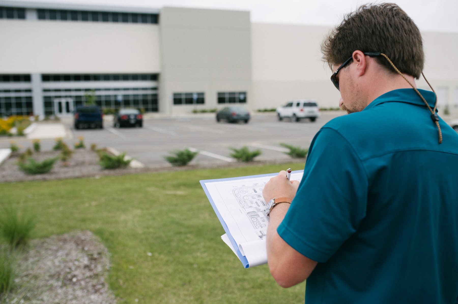 Landscape account manager inspecting job site