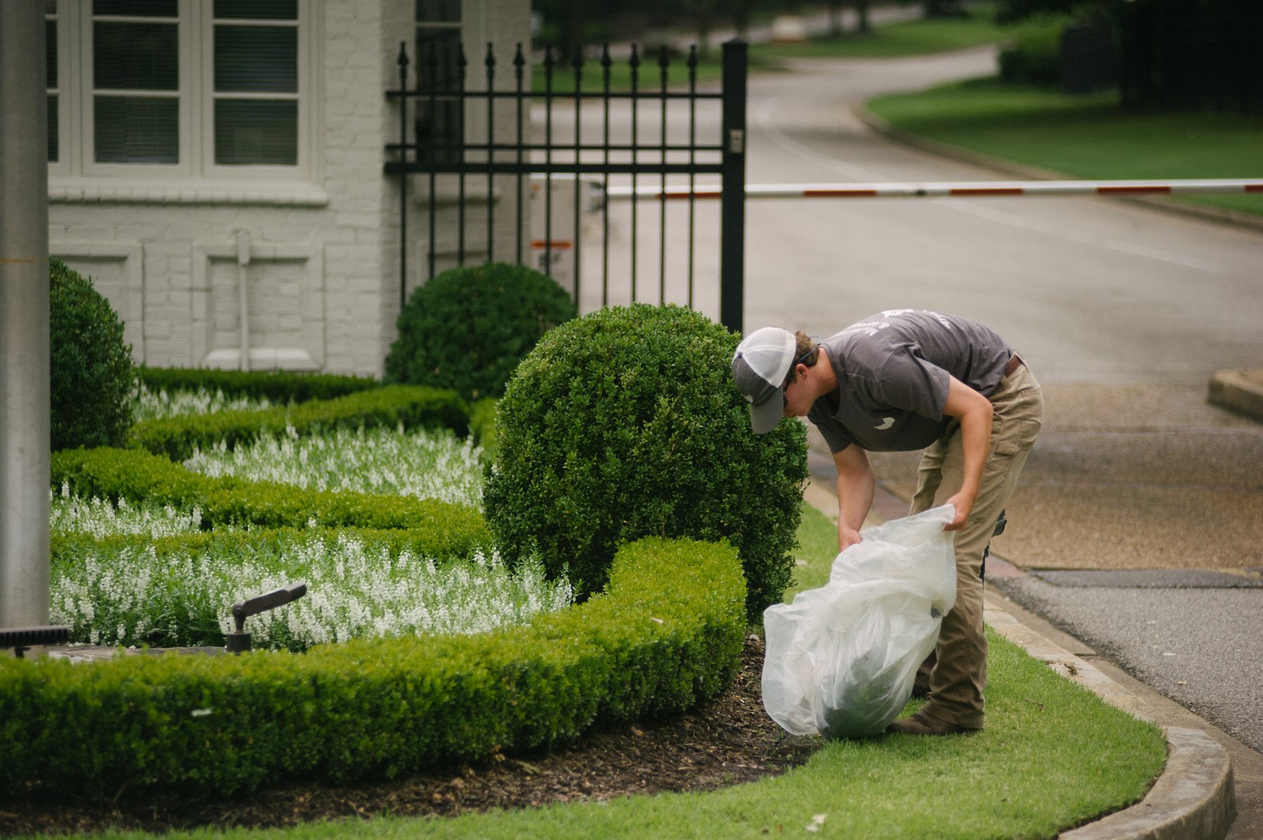 Commercial landscaping team cleaning up trash