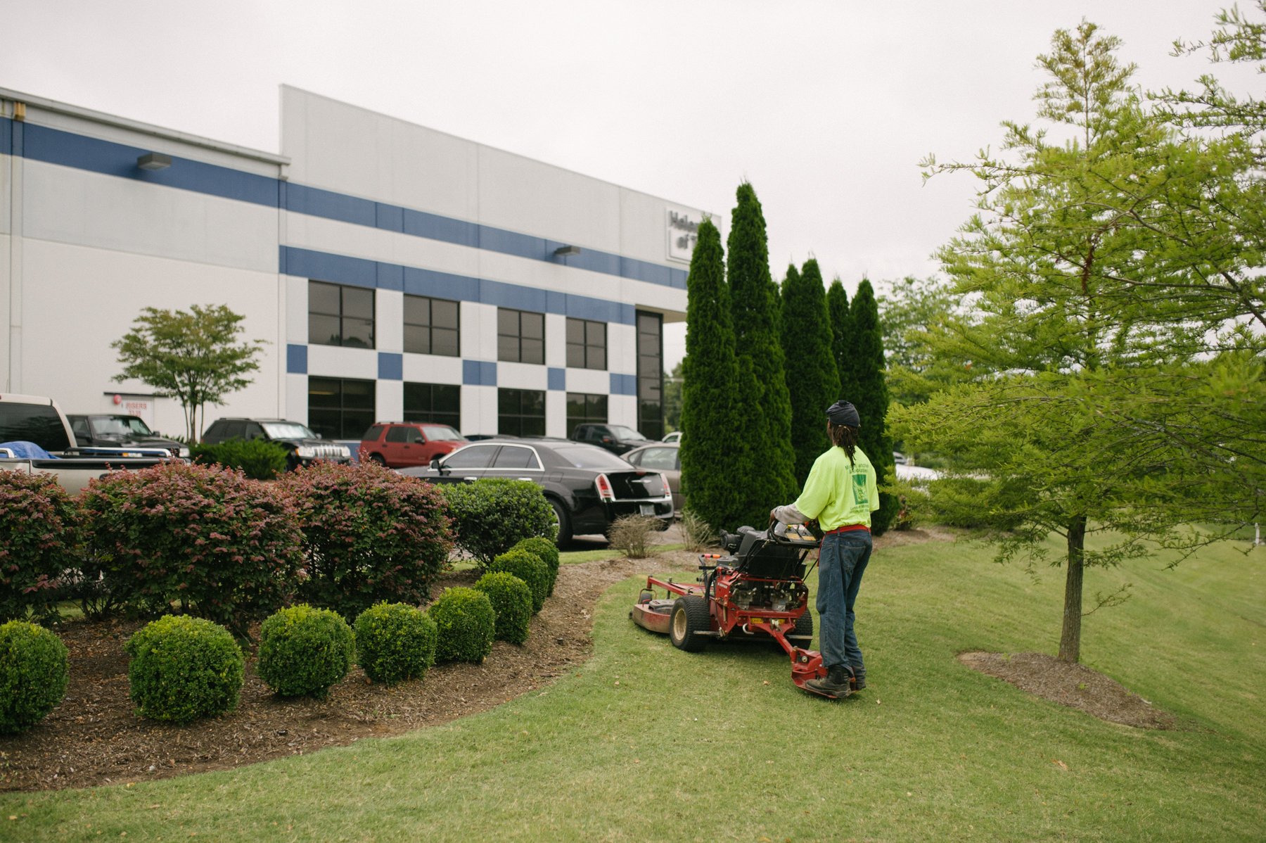 commercial landscape maintenance technician mowing