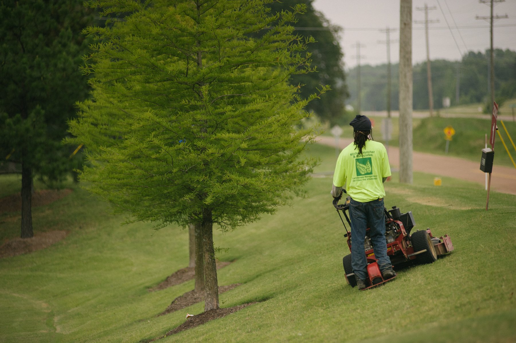 commercial landscape technician mowing