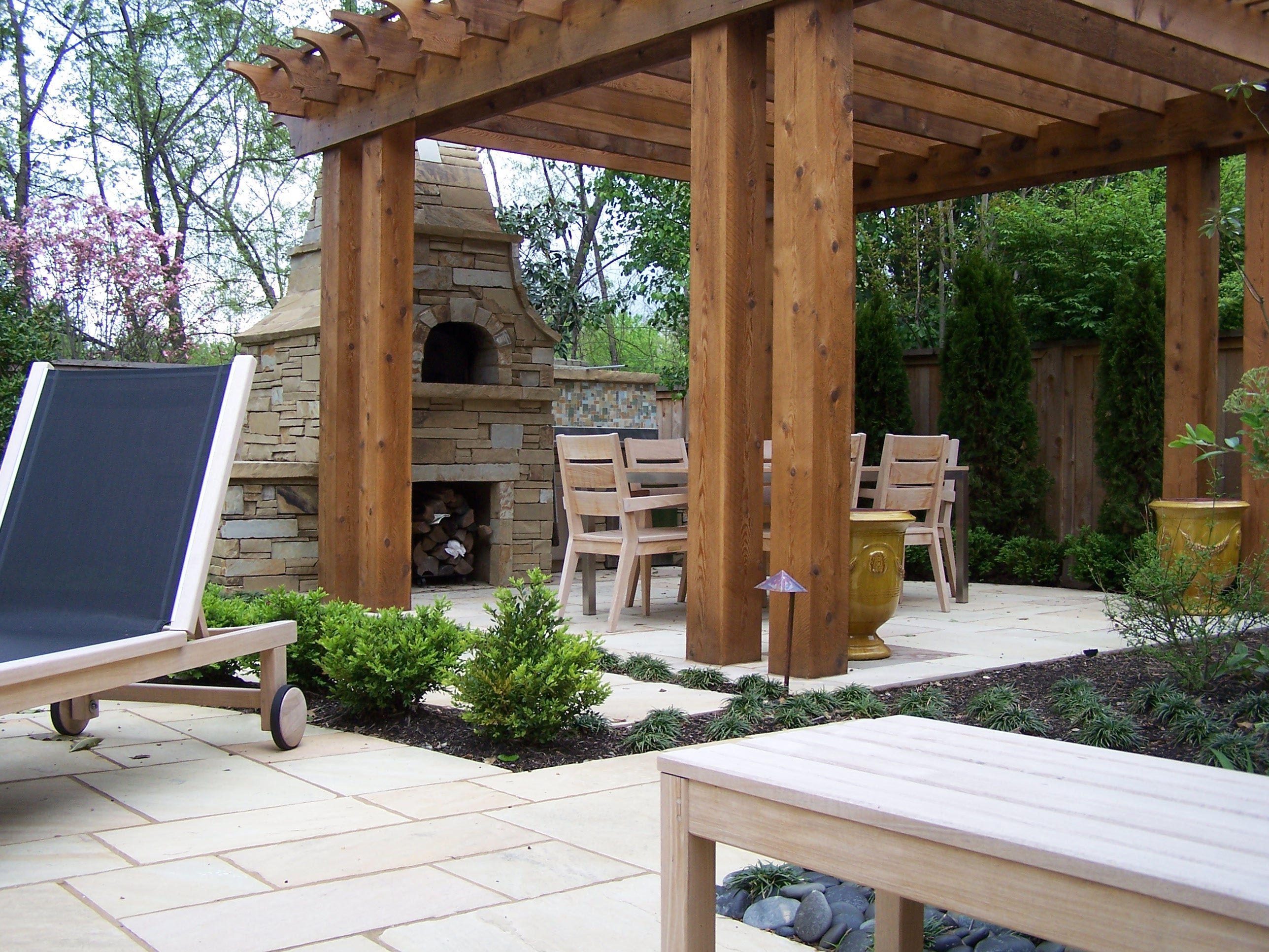 outdoor fireplace and pergola with table