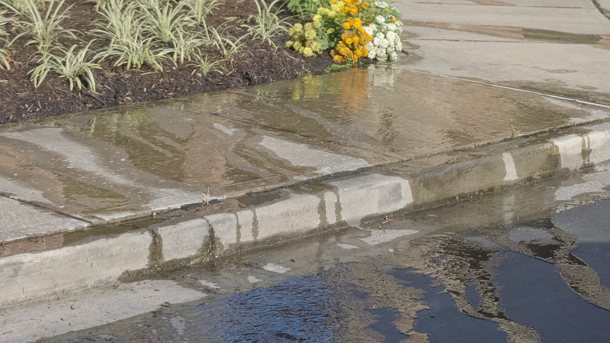 irrigation system leaking water into parking lot
