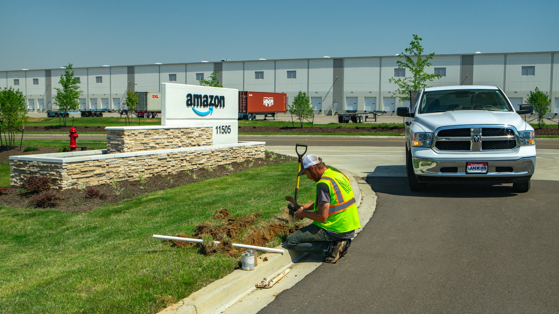 landscape professional repairs irrigation system at amazon industrial property