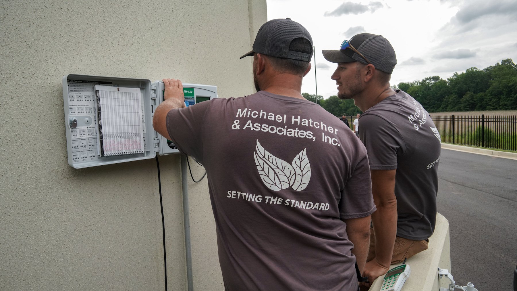 irrigation technicians inspect irrigation controller